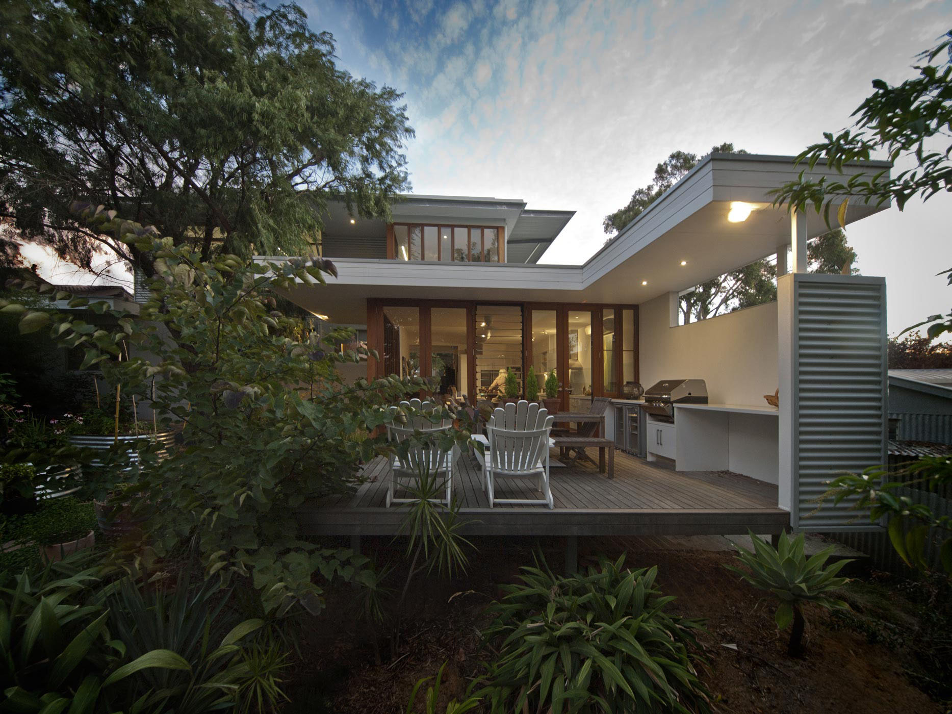 Modern home at dusk with outdoor living